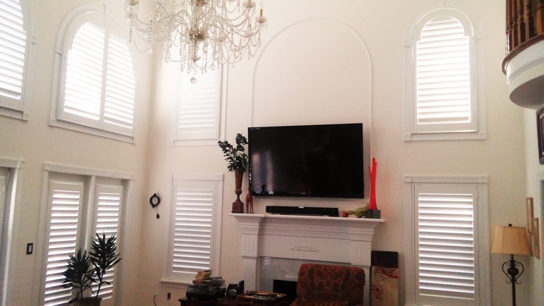 Gainesville great room with mounted television and arc windows.